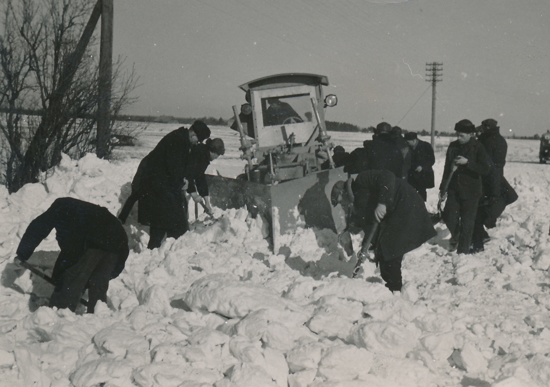 Pärast suure majanduskriisi leevenemist hakati alates 1936. aastast  taas suuremal hulgal lumesahkasi valmistama. 1940. aasta alguse seisuga oli Eestis kasutusel kokku üle 40 mitmesuguse lumesaha. Need jagunesid teehöövlile, traktorile ja veoautole kinnitatavaiks. Teehöövlitega lumetõrje puuduseks loeti, et puhastatud teeala äärde tekkisid järskude servadega vallid ja need tuli kiiresti käsitsi lumelabidaga tasandada, et vähendada tee kinnituiskamise ohtu. (Foto: Eesti Maanteemuuseum)